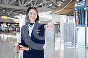 Portrait of beautiful Caucasian flight attendant staff smiling and looking at camera with confidence face and happiness in airport photo