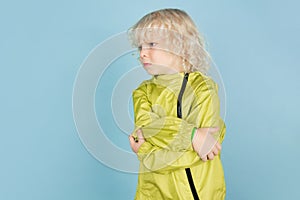 Portrait of beautiful caucasian little boy isolated on blue studio background