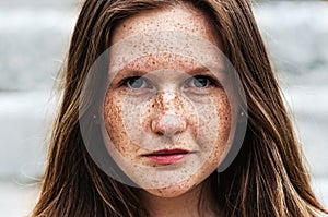 Portrait of a beautiful redhead girl with freckles photo