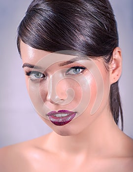 Portrait of a Beautiful Caucasian Woman With Cat Blue Eyes, Full Bourgundy Red Lips and Open Mouth on Grey Background