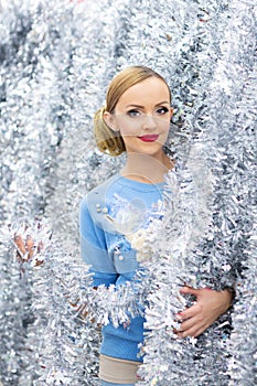 A portrait of beautiful Caucasian woman with Christmas garland decorations