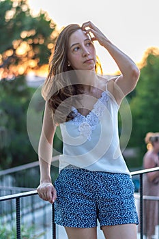 Portrait of beautiful caucasian woman serious and looking at the park during sunset. Outdoor portrait of a serious caucasian girl