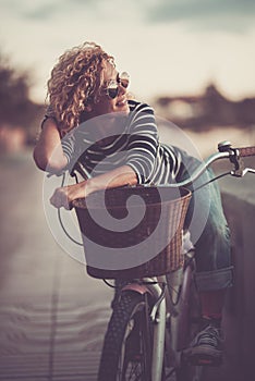 Portrait of beautiful and cheerful young woman enjoy outdoor leisure activity alone with a bike - active people and trendy female