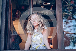 portrait of beautiful child, girl in window