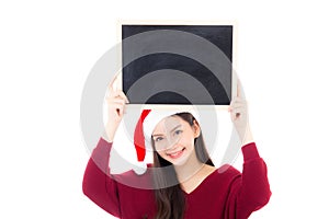 Portrait of beautiful christmas asian young woman in santa hat holding chalkboard