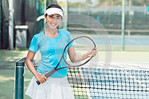 Portrait of a beautiful and competitive Asian tennis player