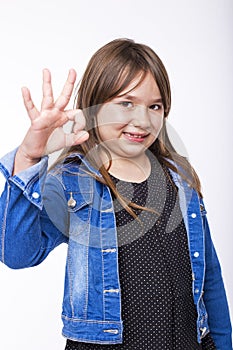 Portrait of a beautiful and confident girl showing ok sign