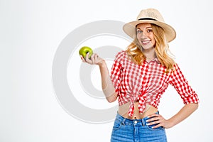 Portrait of beautiful country girl with apple over white background.