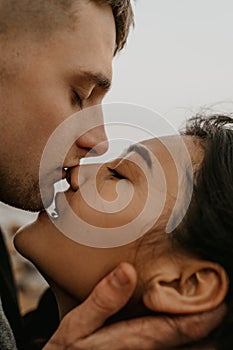 Portrait of a beautiful couple in love. Tender kiss