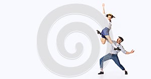 Portrait of beautiful couple, man and woman, dancing swing, rock or lindy hop isolated over white studio background