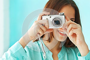 Portrait of a beautiful cute teen girl with digital photo camera