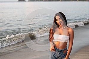 Portrait of a beautiful diverse latina woman smiling on the beach. Hispanic lifestyle concept