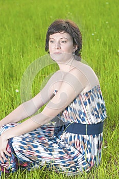 Portrait of Beautiful Dreaming Relaxing Caucasian Brunette Woman Posing Outdoors.