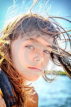 Portrait of a beautiful eight year old girl with the wind blowin