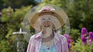 Portrait of a beautiful elderly woman in her garden enjoying retirement.