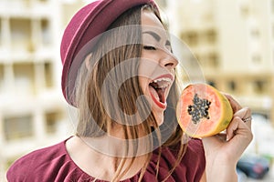 Portrait of beautiful elegant female papaya fruit next to her face