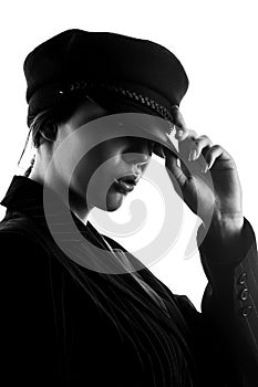 Portrait of a beautiful elegant girl in a beret and suit. Black and white photo