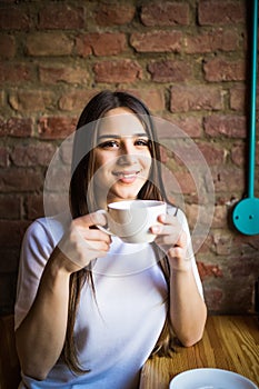 Portrait of beautiful elegant woman with coffee cup