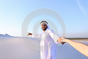 Portrait of beautiful Emirate male tourist guide, who holds woma