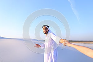 Portrait of beautiful Emirate male tourist guide, who holds woma