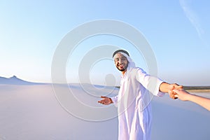 Portrait of beautiful Emirate male tourist guide, who holds woma