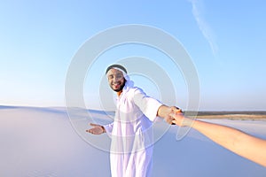 Portrait of beautiful Emirate male tourist guide, who holds woma