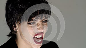 Portrait of beautiful emotional woman with angry grimace on face, to be aggressive.