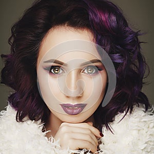 Portrait of beautiful fashion model with purple hair over g