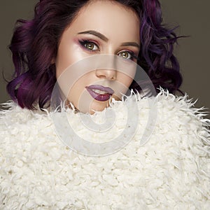 Portrait of beautiful fashion model with purple hair over g