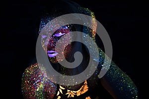 Portrait of Beautiful Fashion Woman in Neon UF Light. Model Girl with Fluorescent Creative Psychedelic MakeUp, Art