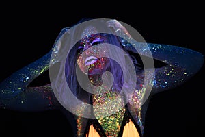 Portrait of Beautiful Fashion Woman in Neon UF Light. Model Girl with Fluorescent Creative Psychedelic MakeUp, Art