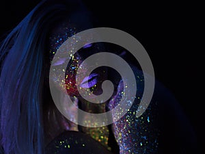 Portrait of Beautiful Fashion Woman in Neon UF Light. Model Girl with Fluorescent Creative Psychedelic MakeUp, Art