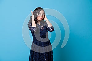 Portrait of a beautiful fashionable Asian woman in a stylish blue dress