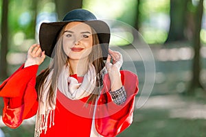 Portrait of a beautiful fashionable girl outdoor on sunny spring day, breating fresh air in park.