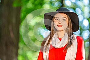 Portrait of a beautiful fashionable girl outdoor on sunny spring day, breating fresh air in park.