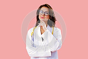 Portrait of beautiful female doctor in glasses thinking and looking ahead