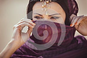 Portrait of a beautiful female model in traditional ethnic costume with heavy jewellery and makeup