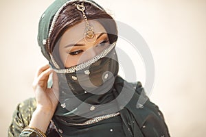 Portrait of a beautiful female model in traditional ethnic costume with heavy jewellery and makeup