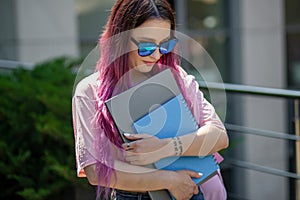 Portrait beautiful female writer dressed in casual outfit holding modern laptop in hand.