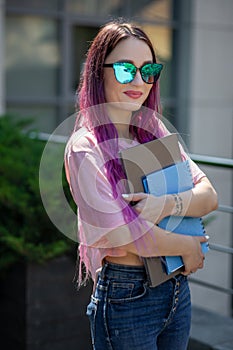 Portrait beautiful female writer dressed in casual outfit holding modern laptop in hand.