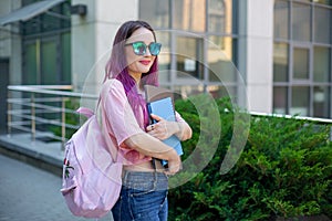 Portrait beautiful female writer dressed in casual outfit holding modern laptop in hand with backpack.