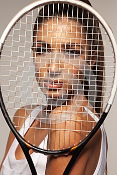 Portrait of beautiful fitness woman, tennis player with racket.