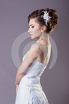 Portrait of a beautiful gentle and elegant girl women bride in a white dress with a beautiful hairstyle and makeup