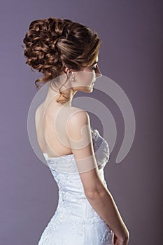 Portrait of a beautiful gentle and elegant girl women bride in a white dress with a beautiful hairstyle and makeup