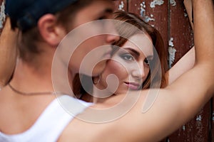 Portrait of a beautiful ginger girl standing with a man over woo