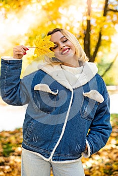Portrait of beautiful girl in autumn park, spend and enjoy free time at nature