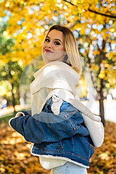 Portrait of beautiful girl in autumn park, spend and enjoy free time at nature