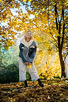 Portrait of beautiful girl in autumn park, spend and enjoy free time at nature