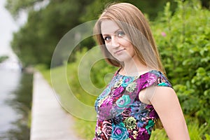 Portrait of a beautiful girl on a background of the river