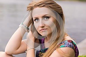 Portrait of a beautiful girl on a background of the river